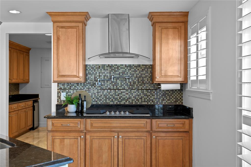 19730 Gulf Boulevard, Unit 400 Indian Rocks Beach, FL 33785 - Photo 31 of 90 a kitchen with stainless steel appliances granite countertop a stove a sink and a refrigerator
