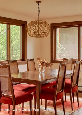 a kitchen with stainless steel appliances kitchen island granite countertop a table and chairs in it