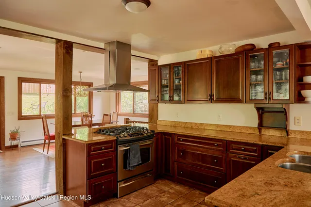 a kitchen with a table chairs and white cabinets