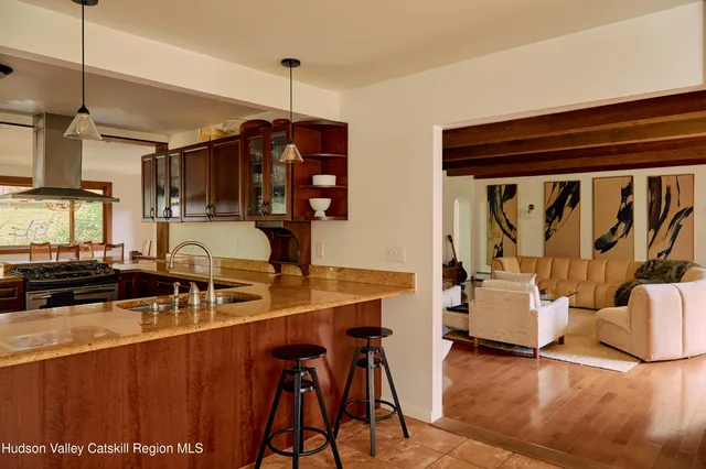 a view of a kitchen with dining table and chairs