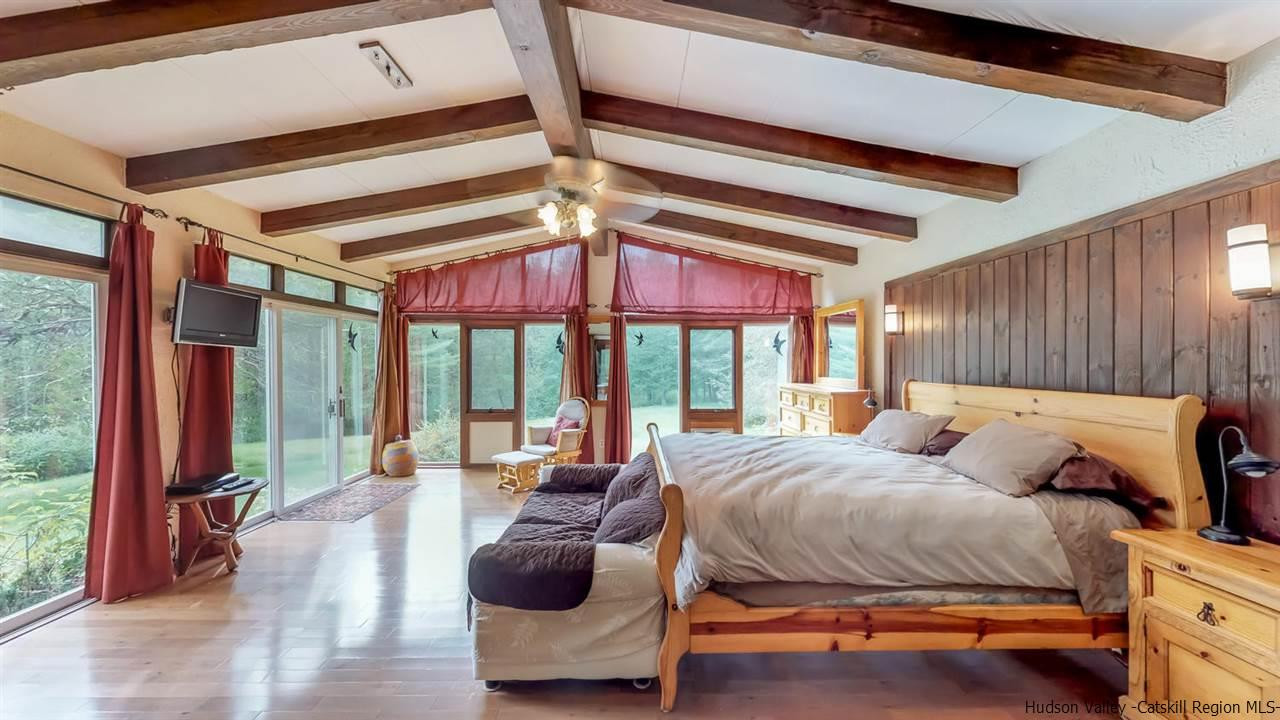 33 Race Track Road Bearsville, NY 12409 - Photo 20 of 37 a bedroom with furniture and a large window
