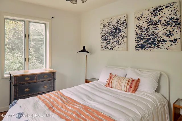 a bedroom with a bed and window