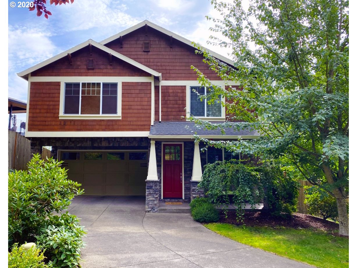 592 Southwest Elderbrook Place Portland, OR 97225 - Photo 1 of 30 a front view of a house with a garden