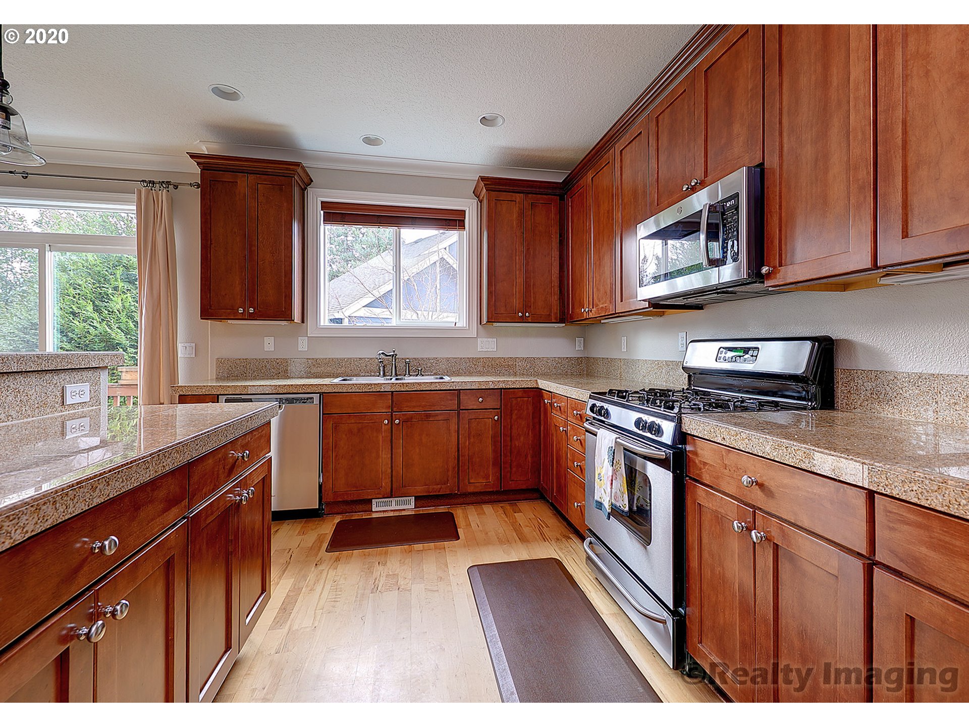 592 Southwest Elderbrook Place Portland, OR 97225 - Photo 12 of 30 a kitchen with stainless steel appliances granite countertop a sink stove and microwave