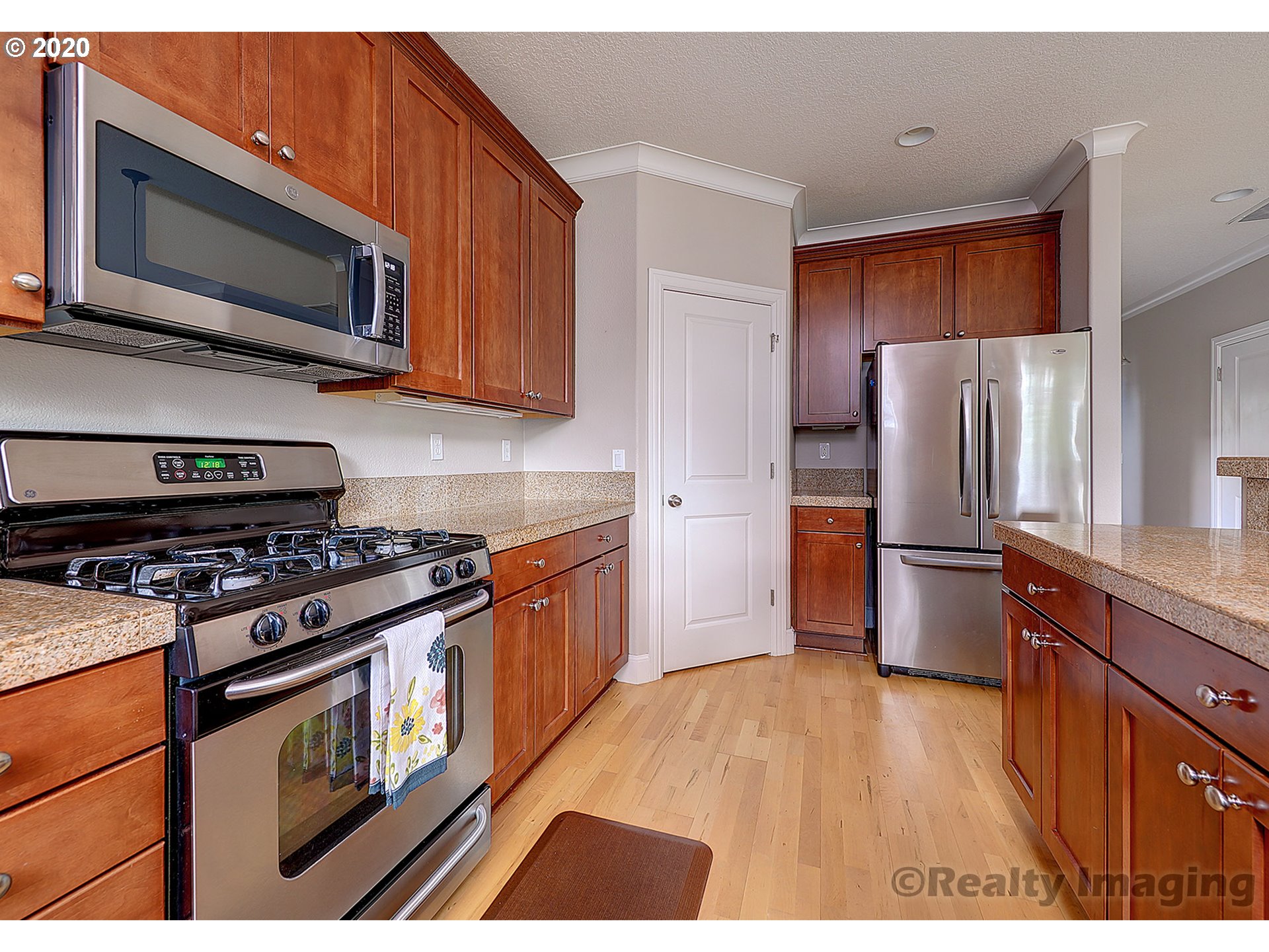 592 Southwest Elderbrook Place Portland, OR 97225 - Photo 13 of 30 a kitchen with stainless steel appliances granite countertop a stove top oven a refrigerator and a granite counter tops