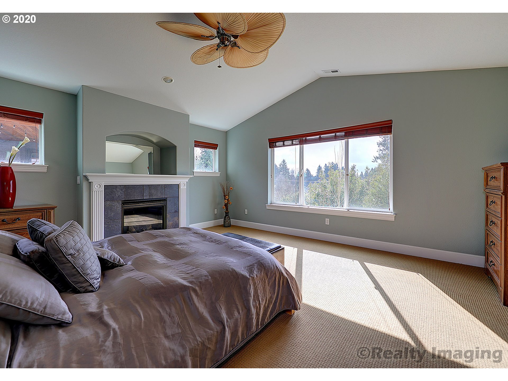 592 Southwest Elderbrook Place Portland, OR 97225 - Photo 16 of 30 a bedroom with a bed and a fireplace