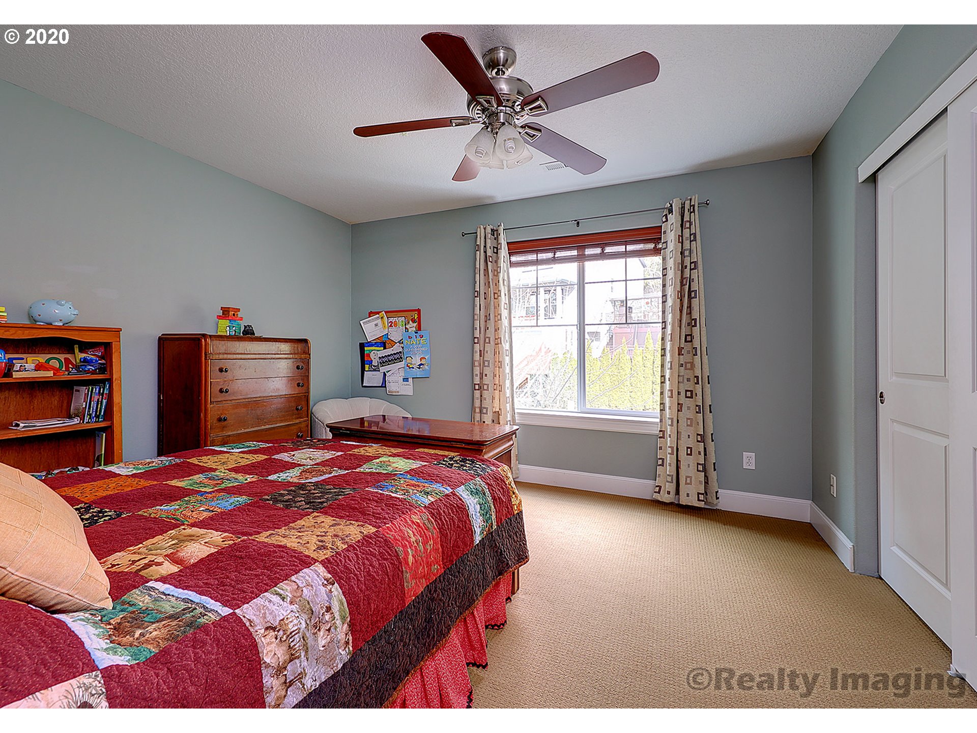 592 Southwest Elderbrook Place Portland, OR 97225 - Photo 22 of 30 a bedroom with a bed and a window