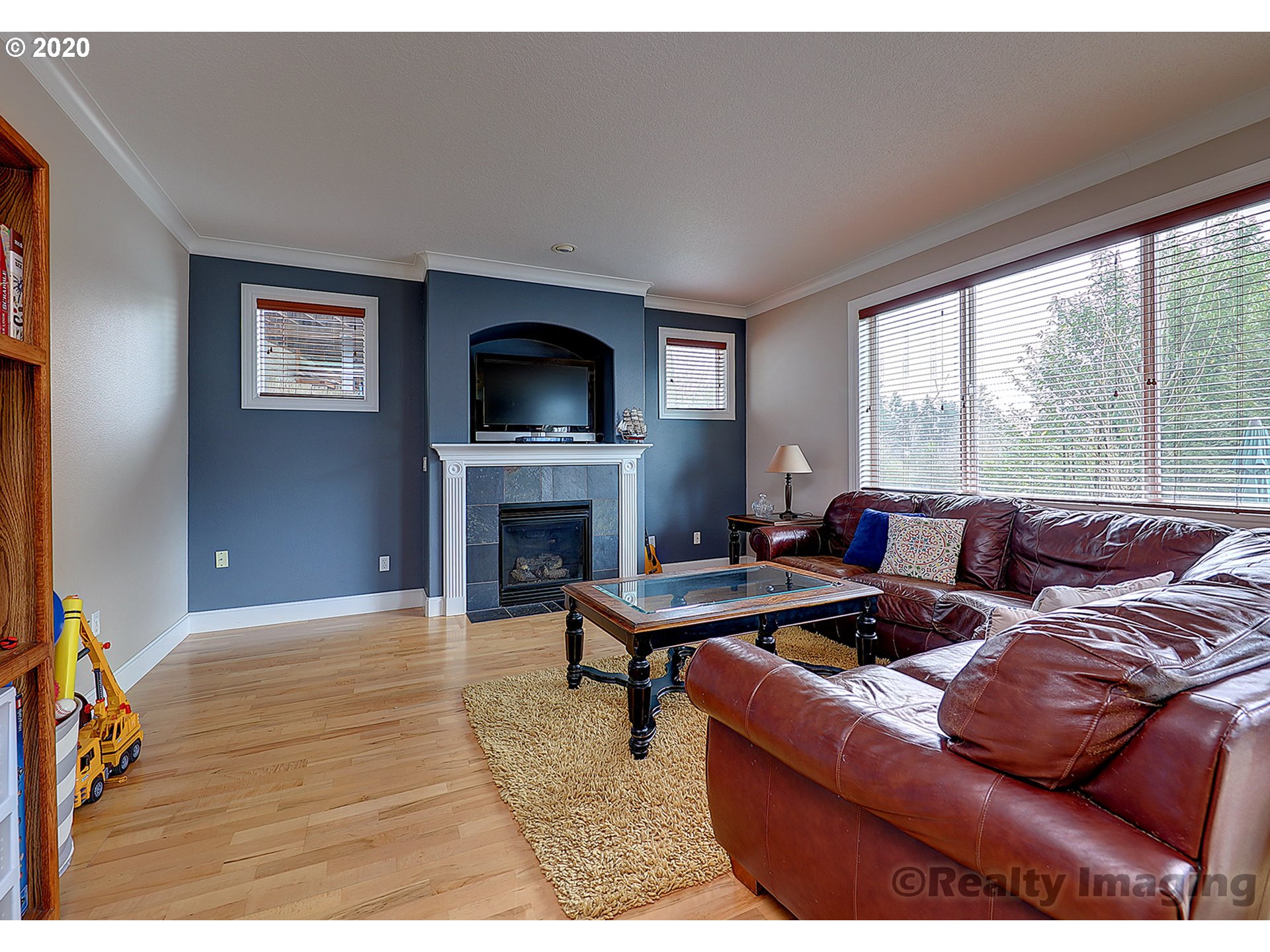 592 Southwest Elderbrook Place Portland, OR 97225 - Photo 5 of 30 a living room with furniture a fireplace and a flat screen tv