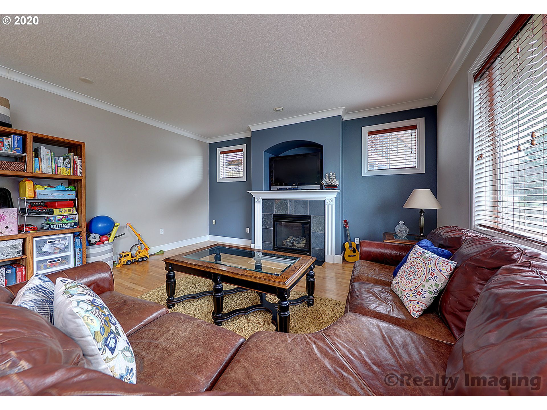 592 Southwest Elderbrook Place Portland, OR 97225 - Photo 6 of 30 a living room with furniture a flat screen tv and a fireplace