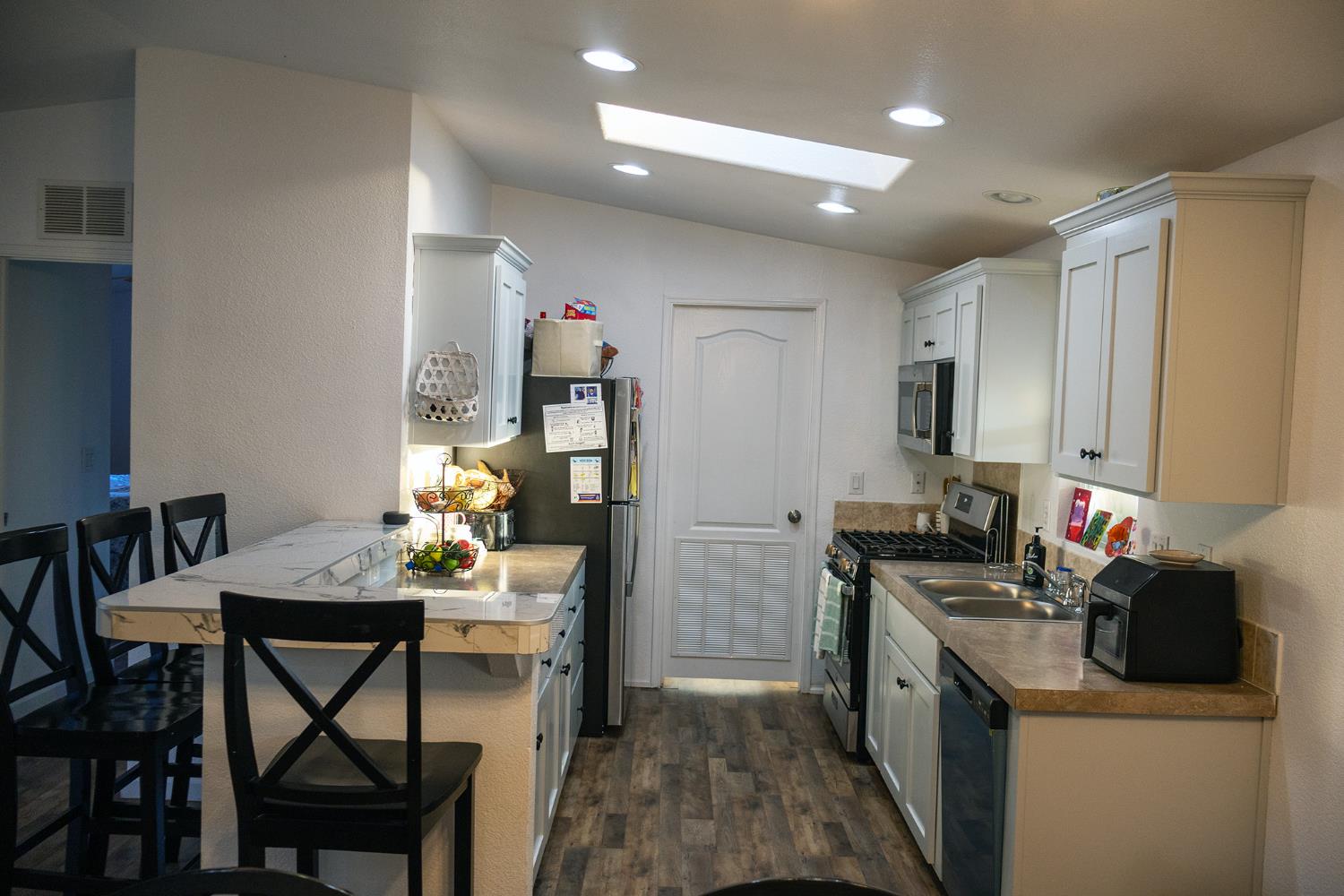 2499 East Gerard Avenue, Unit 123 Merced, CA 95341 - Photo 5 of 15 a kitchen that has a table chairs and refrigerator