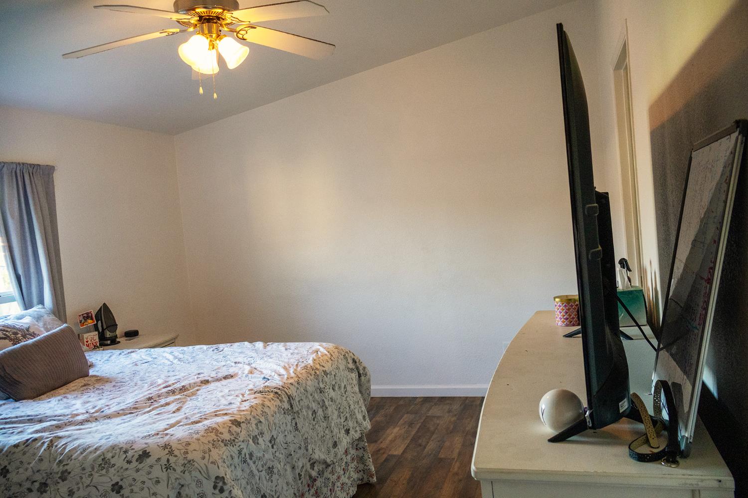 2499 East Gerard Avenue, Unit 123 Merced, CA 95341 - Photo 7 of 15 a bedroom with a bed and a flat screen tv