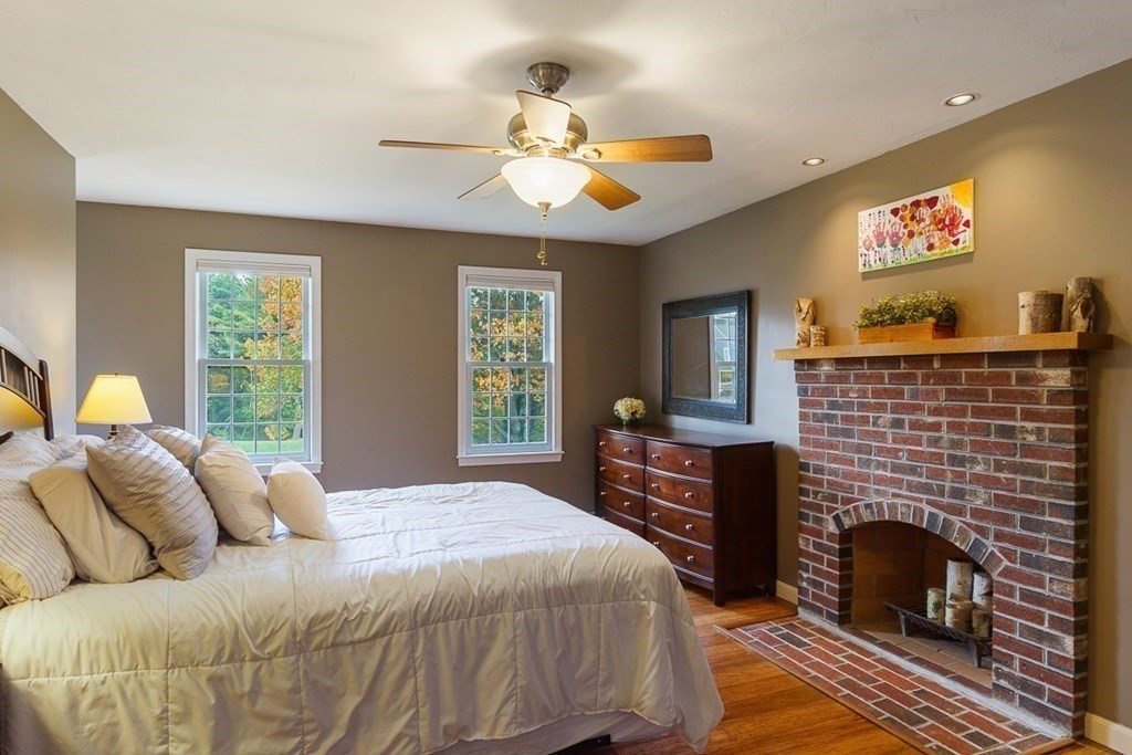 26 Watson Lane Rutland, MA 01543 - Photo 23 of 42 a bedroom with a bed and a fireplace