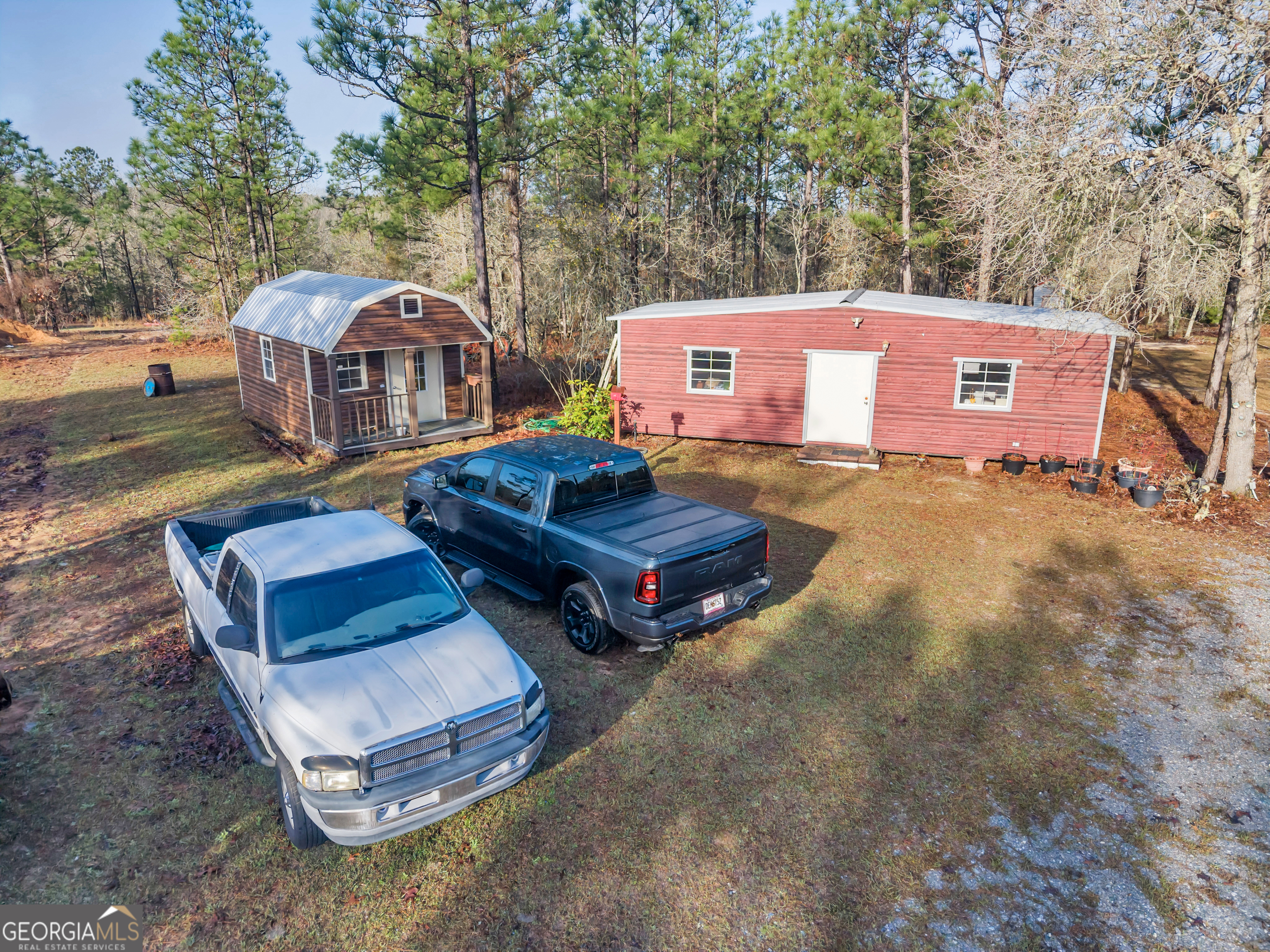 271 Dr Brooks Road Box Springs, GA 31801 - Photo 21 of 63 an aerial view of a house with swimming pool and red chairs