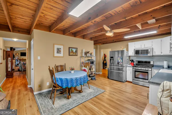 a living room with furniture a flat screen tv and a large window