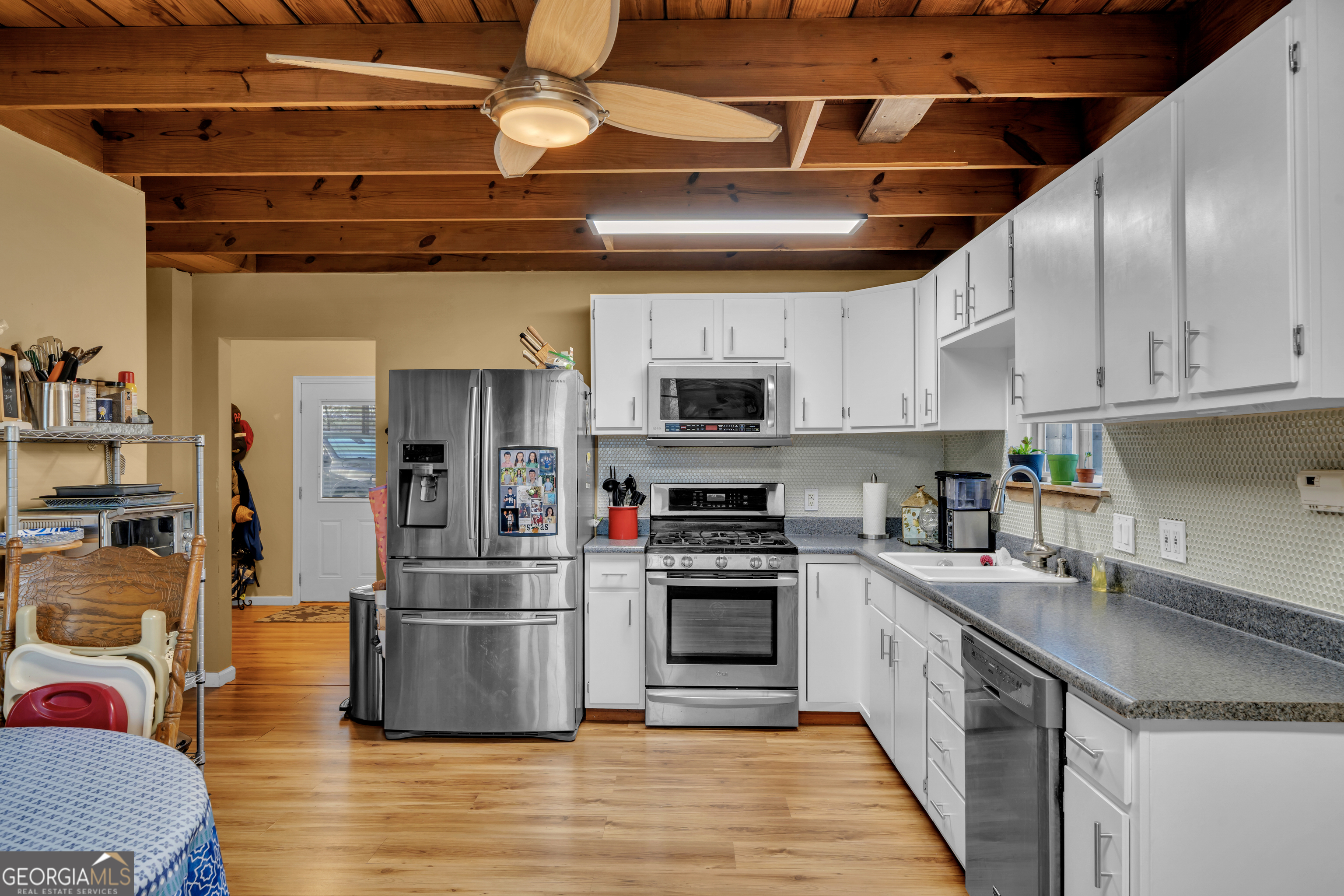 271 Dr Brooks Road Box Springs, GA 31801 - Photo 27 of 63 a kitchen with stainless steel appliances granite countertop a sink a stove and a refrigerator