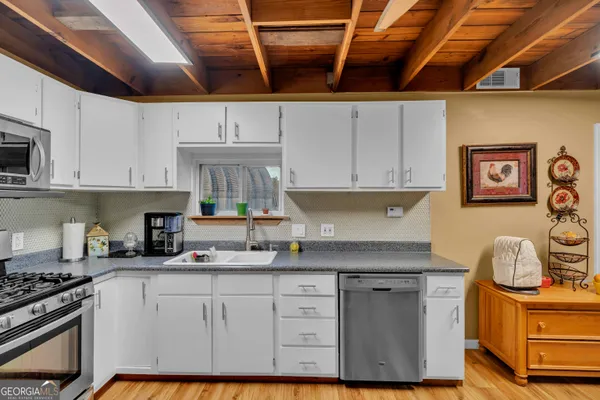 a bedroom with a bed and a flat screen tv with wooden floor