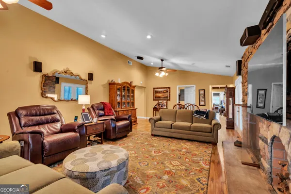 a bedroom with a bed next to a window and a flat screen tv