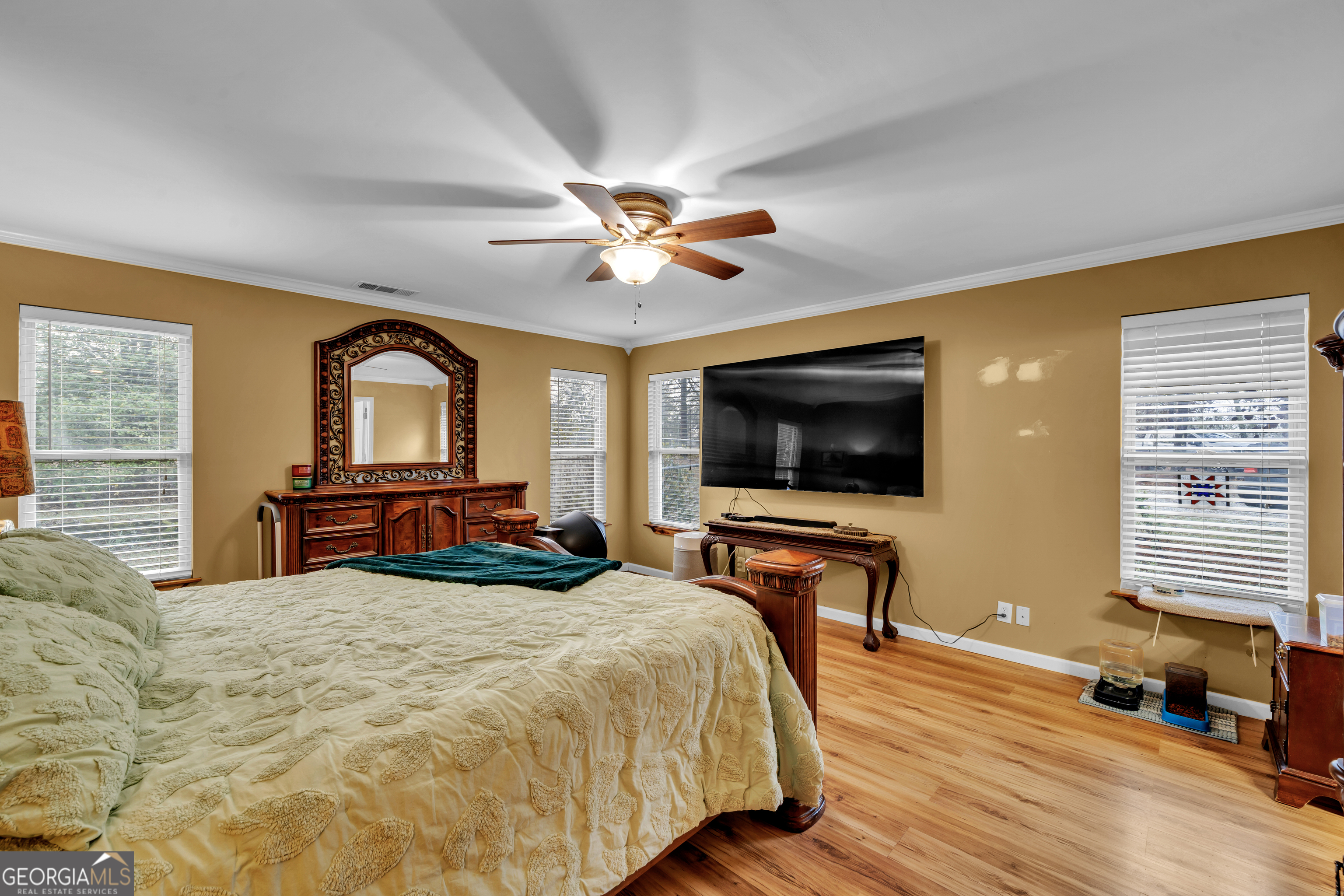 271 Dr Brooks Road Box Springs, GA 31801 - Photo 35 of 63 a bedroom with a bed and a flat screen tv with wooden floor