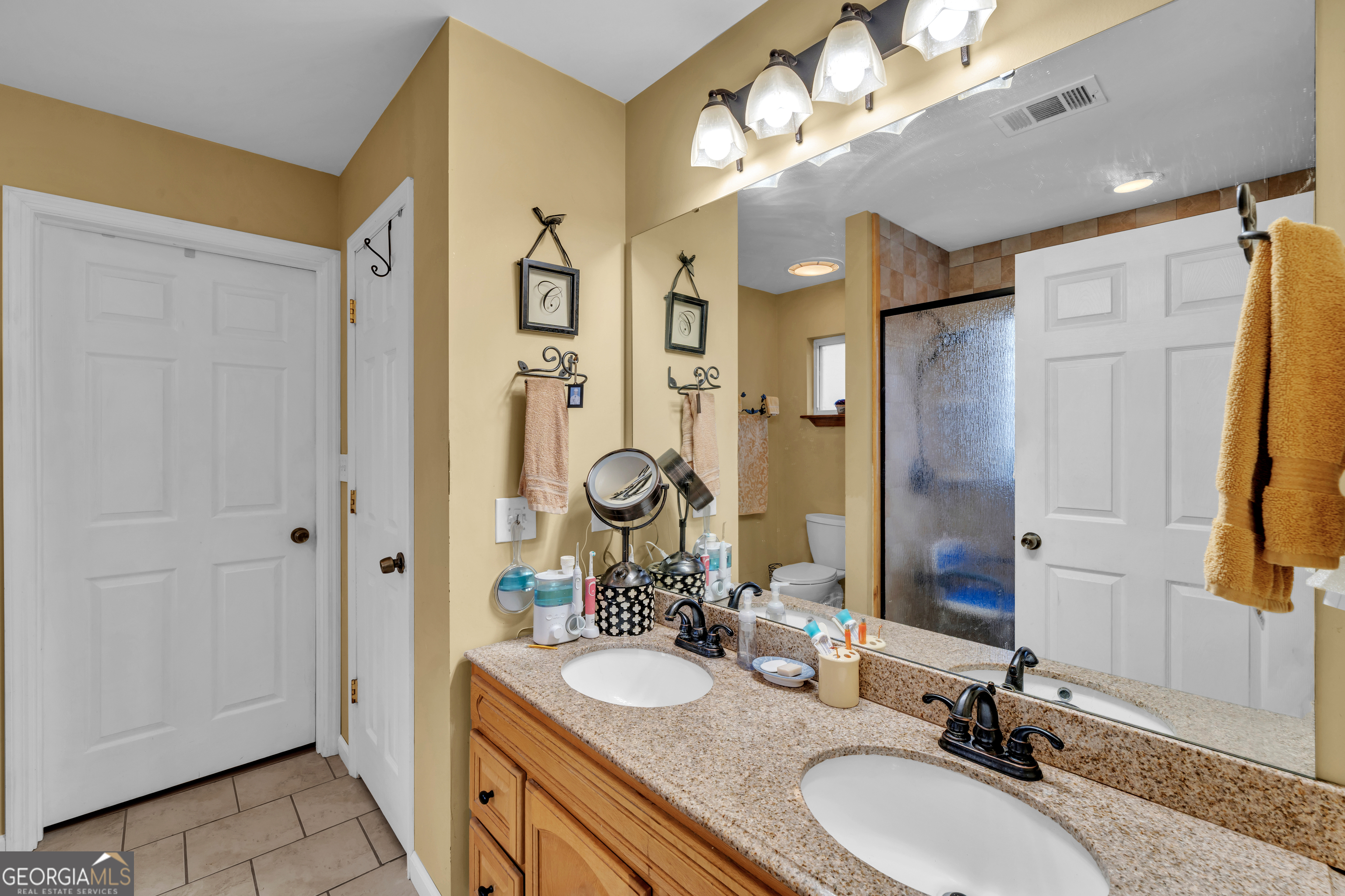 271 Dr Brooks Road Box Springs, GA 31801 - Photo 37 of 63 a bathroom with a granite countertop double vanity sink mirror and shower