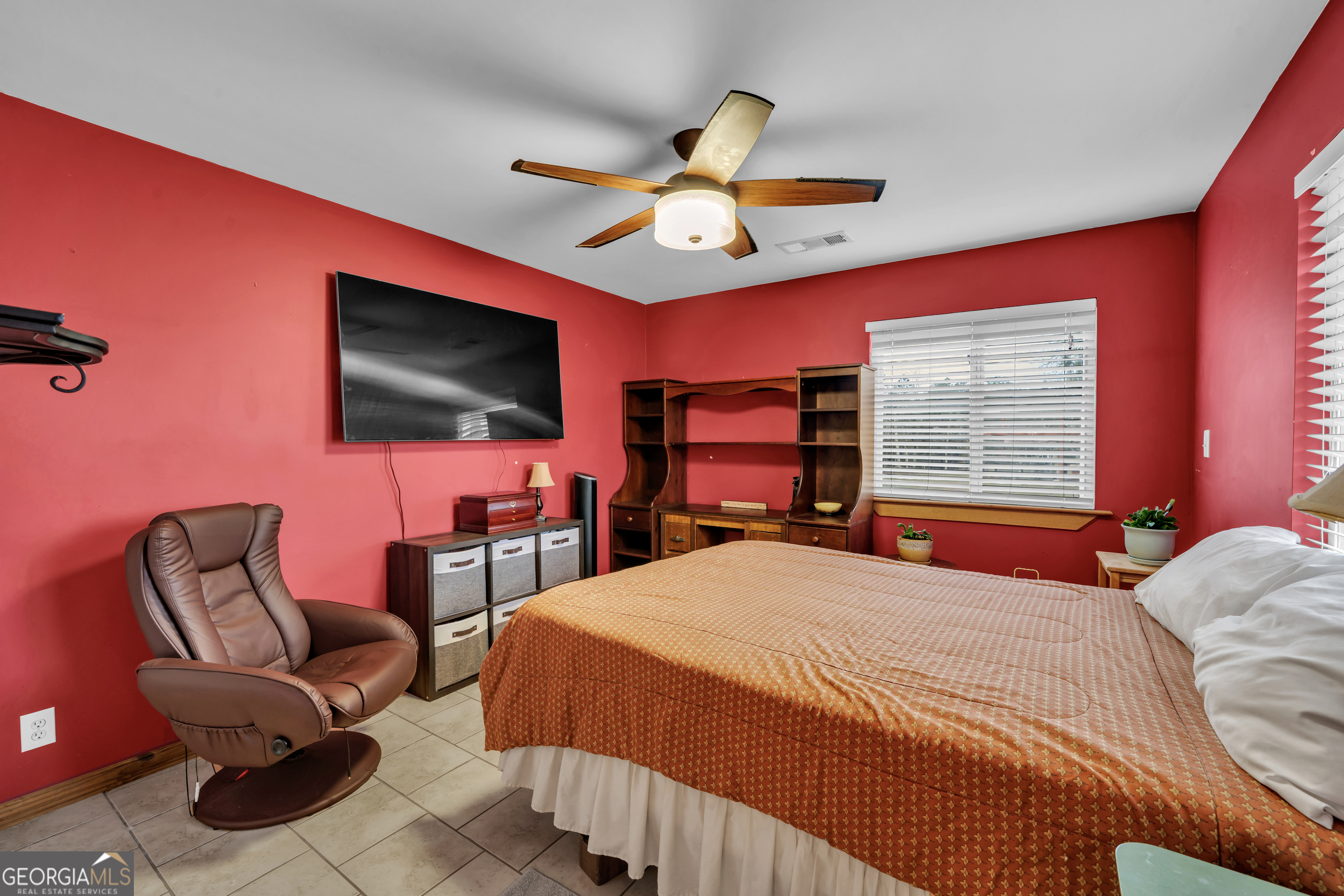 271 Dr Brooks Road Box Springs, GA 31801 - Photo 40 of 63 a bedroom with a bed a chair and a flat screen tv