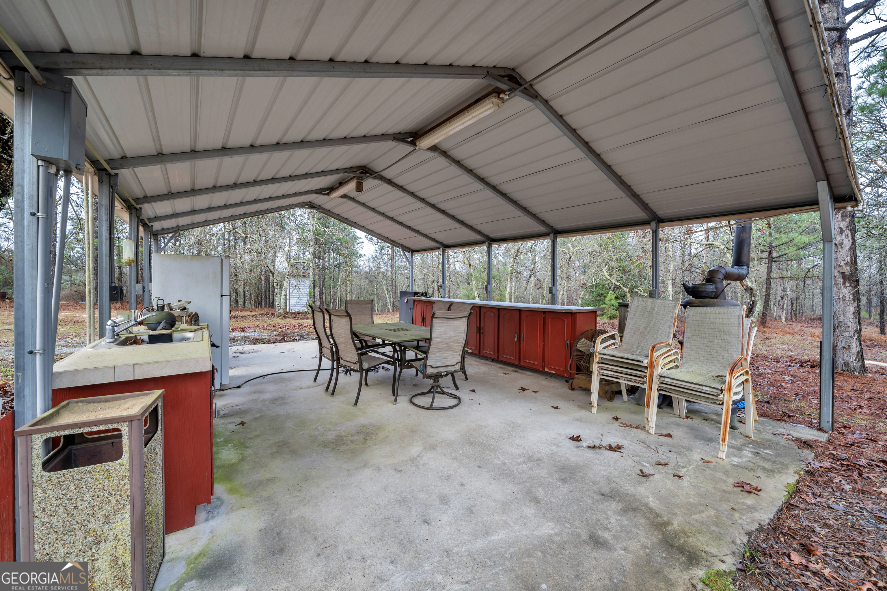 271 Dr Brooks Road Box Springs, GA 31801 - Photo 51 of 63 a view of a patio with table and chairs under an umbrella