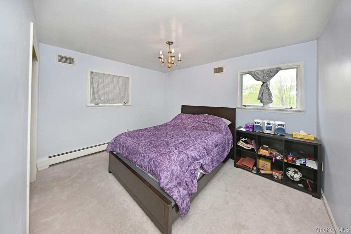 19 Sterling Road Spring Valley, NY 10977 - Photo 12 of 20 a bedroom with a bed dresser and a window