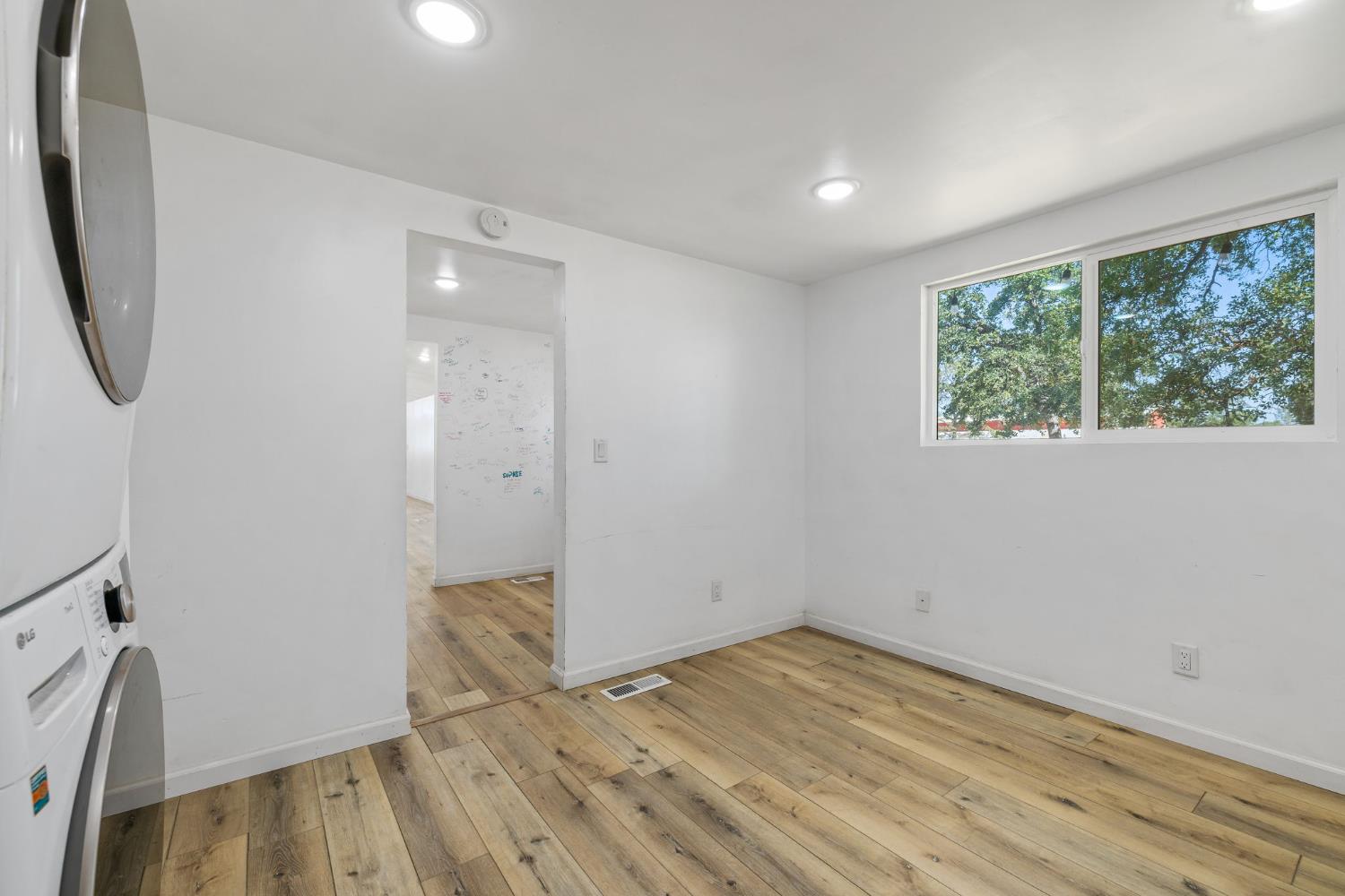 7145 Superior Town Road Lincoln, CA 95648 - Photo 13 of 94 an empty room with wooden floor and windows