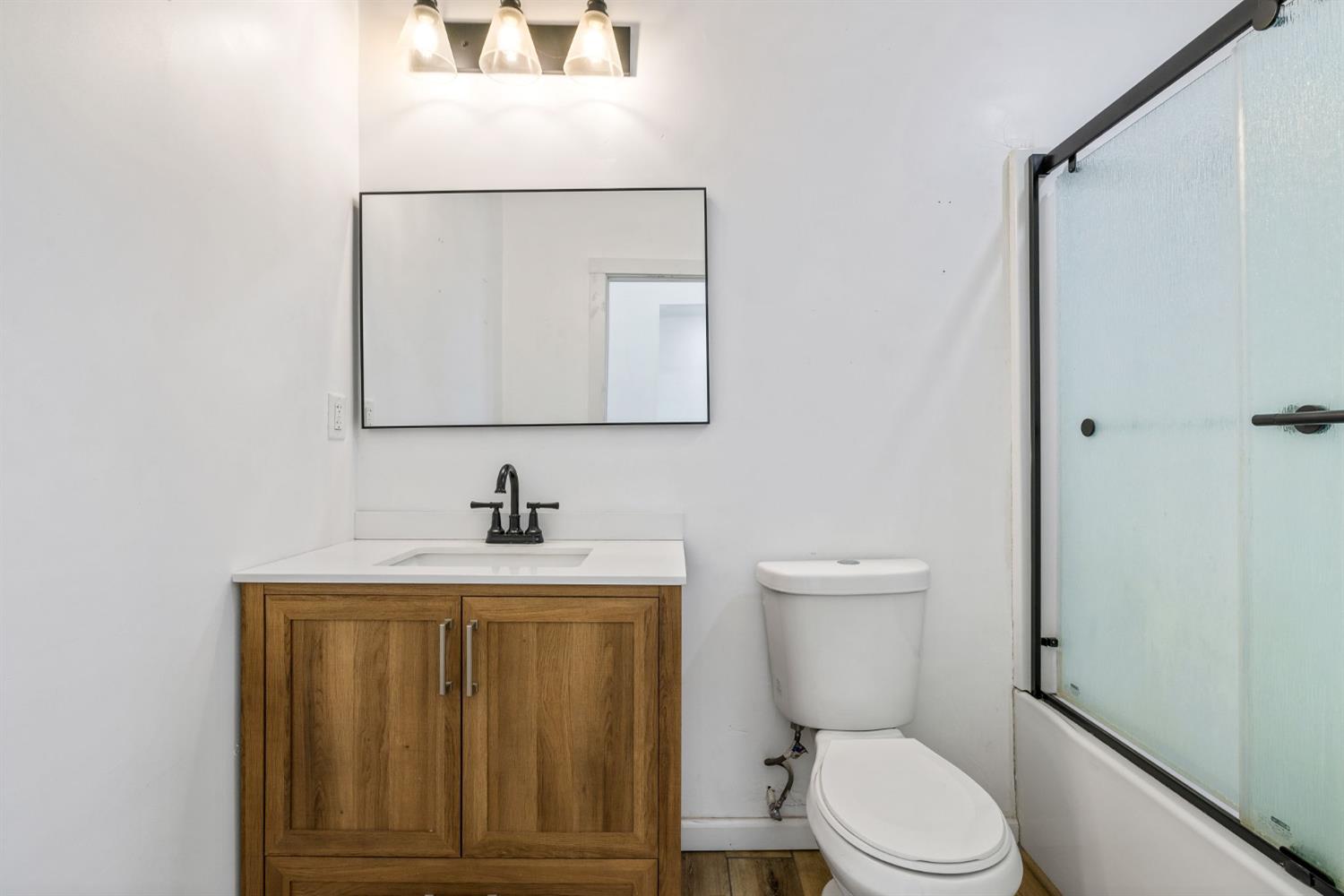 7145 Superior Town Road Lincoln, CA 95648 - Photo 24 of 94 a bathroom with a toilet a sink and mirror