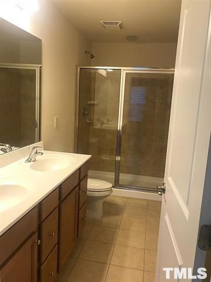 473 Panorama View Loop Cary, NC 27519 - Photo 14 of 17 a bathroom with a double vanity sink toilet and shower