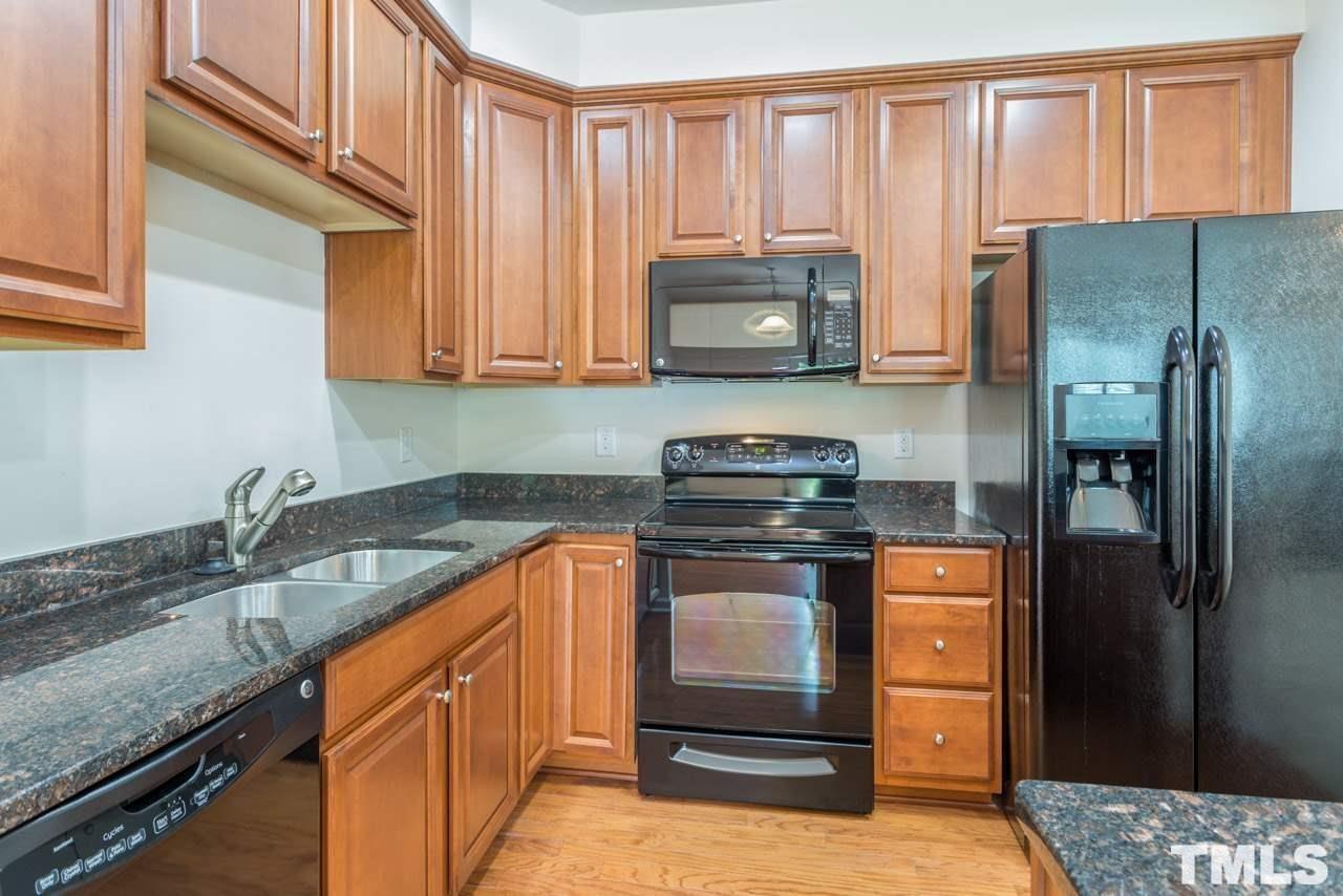 473 Panorama View Loop Cary, NC 27519 - Photo 4 of 17 a kitchen with stainless steel appliances granite countertop a refrigerator a stove and a sink