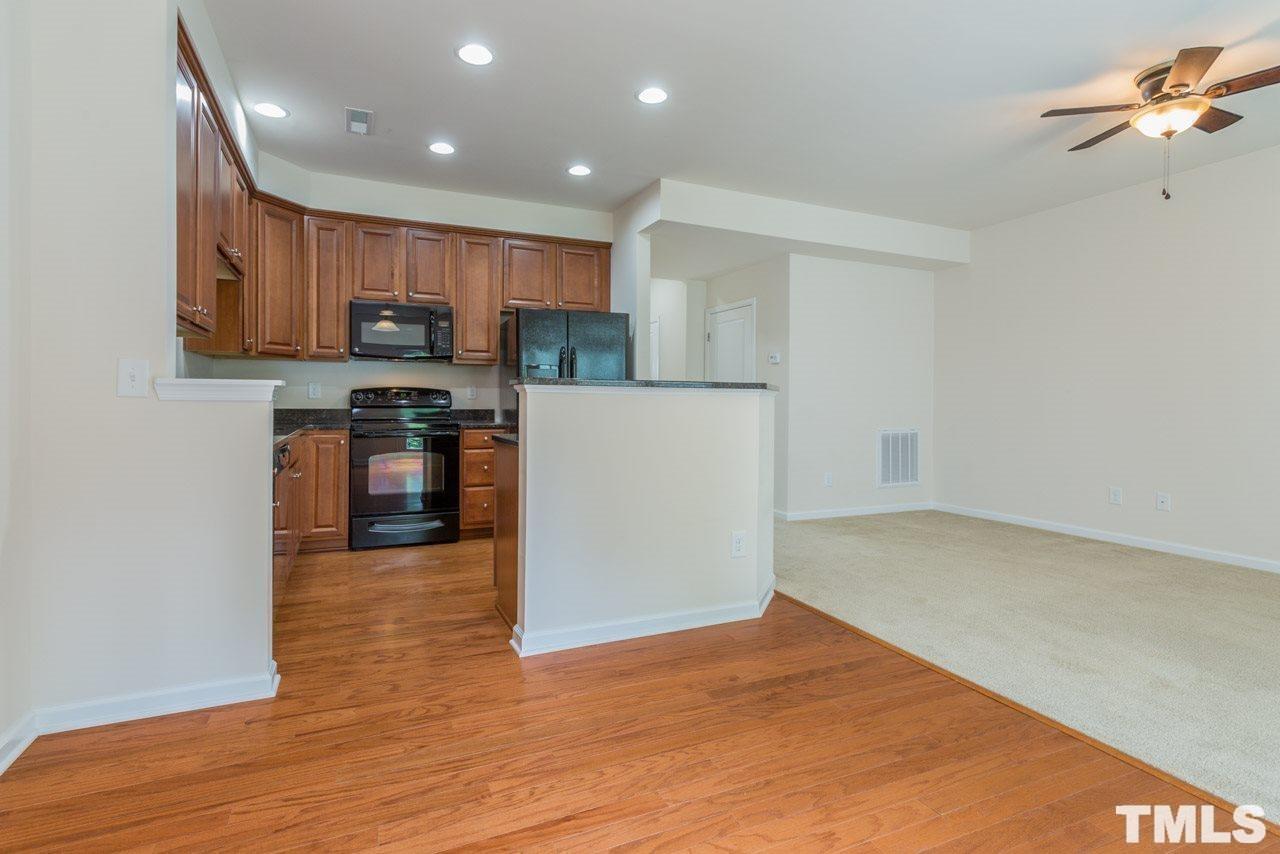 473 Panorama View Loop Cary, NC 27519 - Photo 5 of 17 a kitchen with stainless steel appliances granite countertop a refrigerator a stove top oven a sink and dishwasher