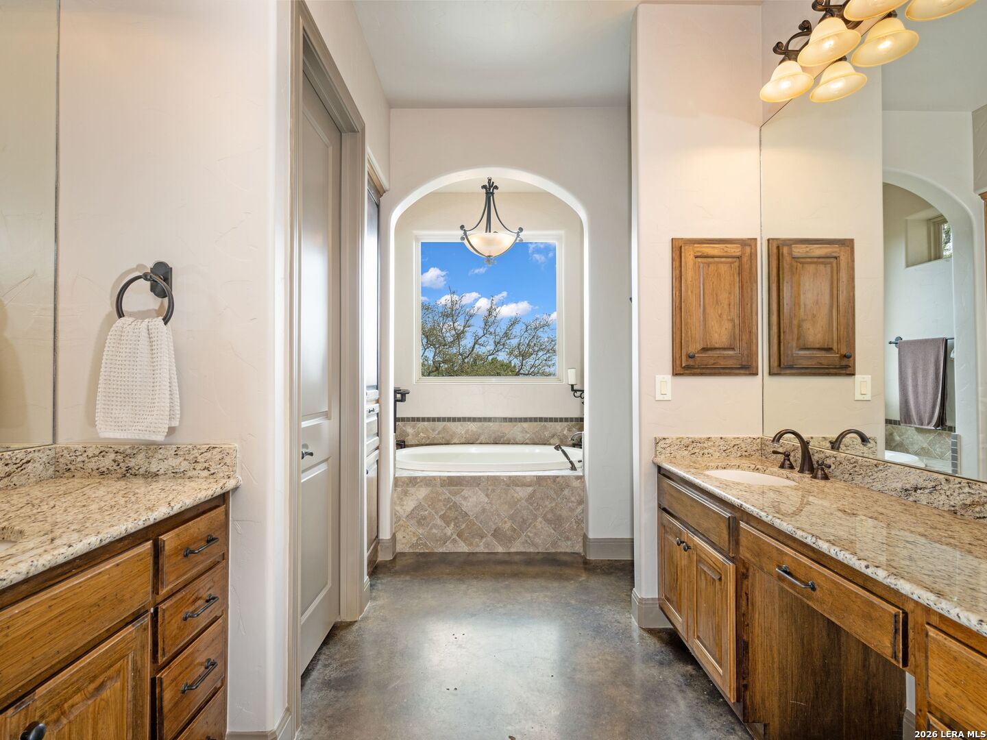 2601 B And R Road Utopia, TX 78884 - Photo 27 of 70 a bathroom with a granite countertop double vanity sink and a mirror