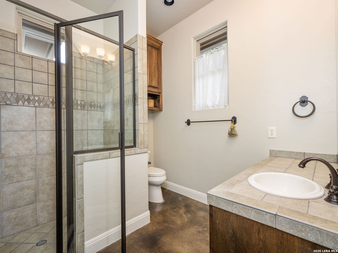 2601 B And R Road Utopia, TX 78884 - Photo 33 of 70 a bathroom with a sink toilet and shower