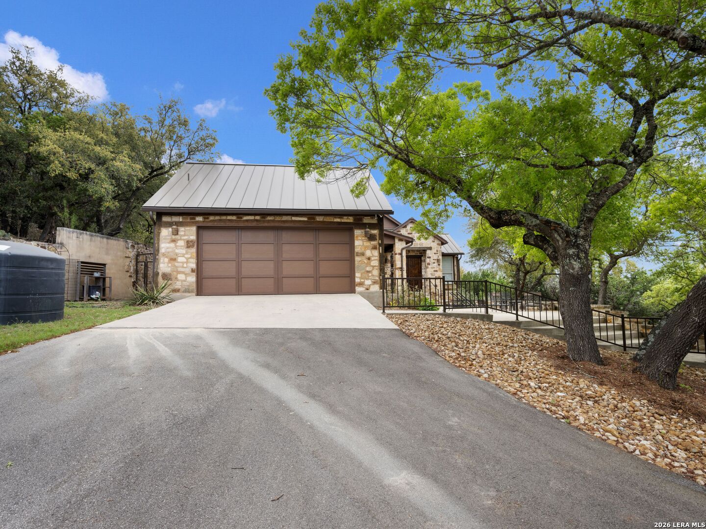 2601 B And R Road Utopia, TX 78884 - Photo 43 of 70 a front view of a house with a yard and garage