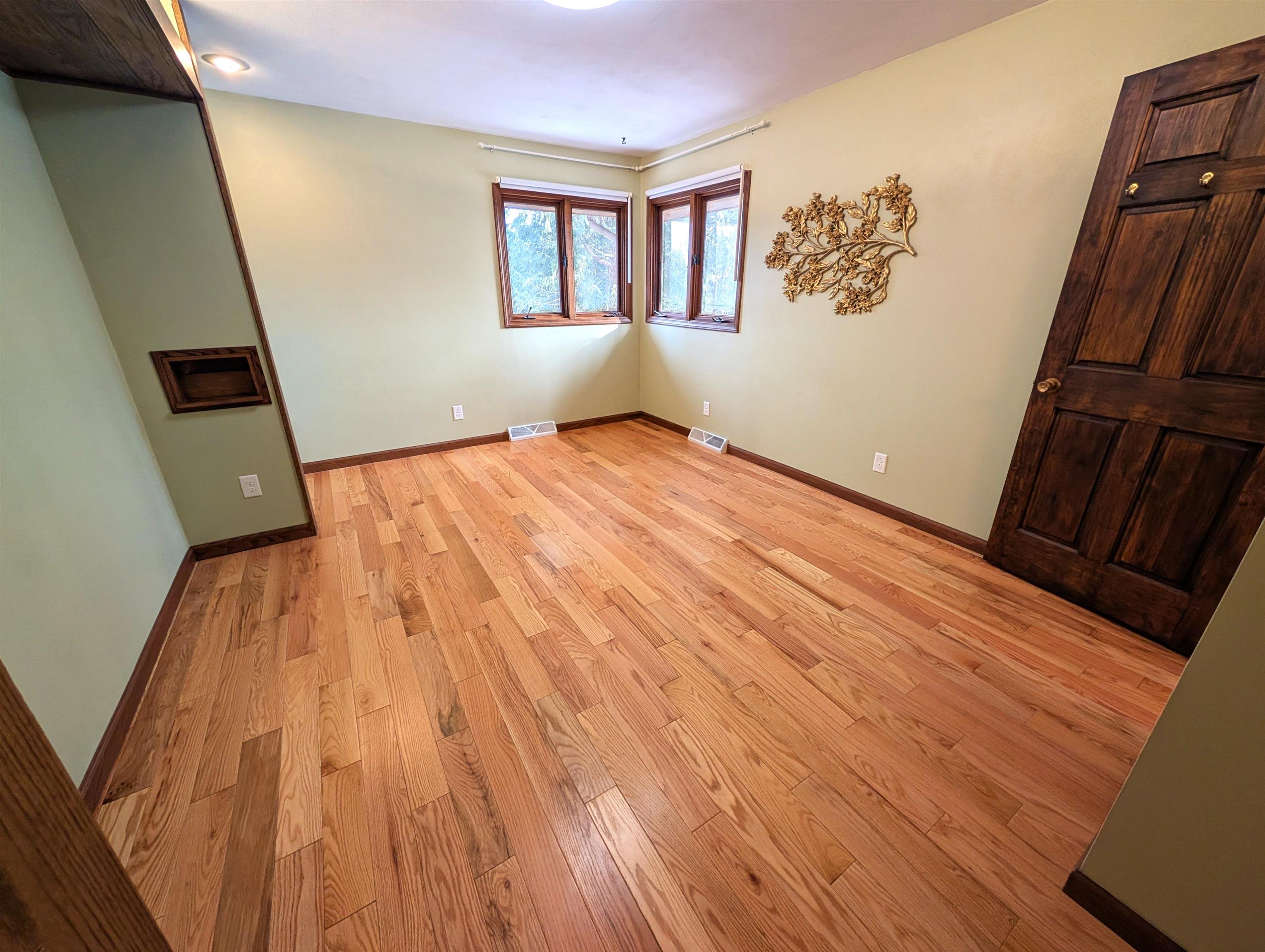 5293 Arbutus Road Rockford, IL 61107 - Photo 12 of 18 a view of an empty room with wooden floor and a window