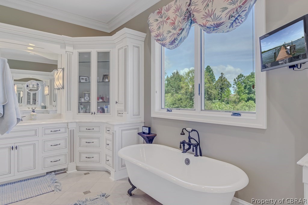 2055 Ditchley Road Kilmarnock, VA 22482 - Photo 31 of 48 Bathroom with tile flooring, vanity, and ornamental molding
