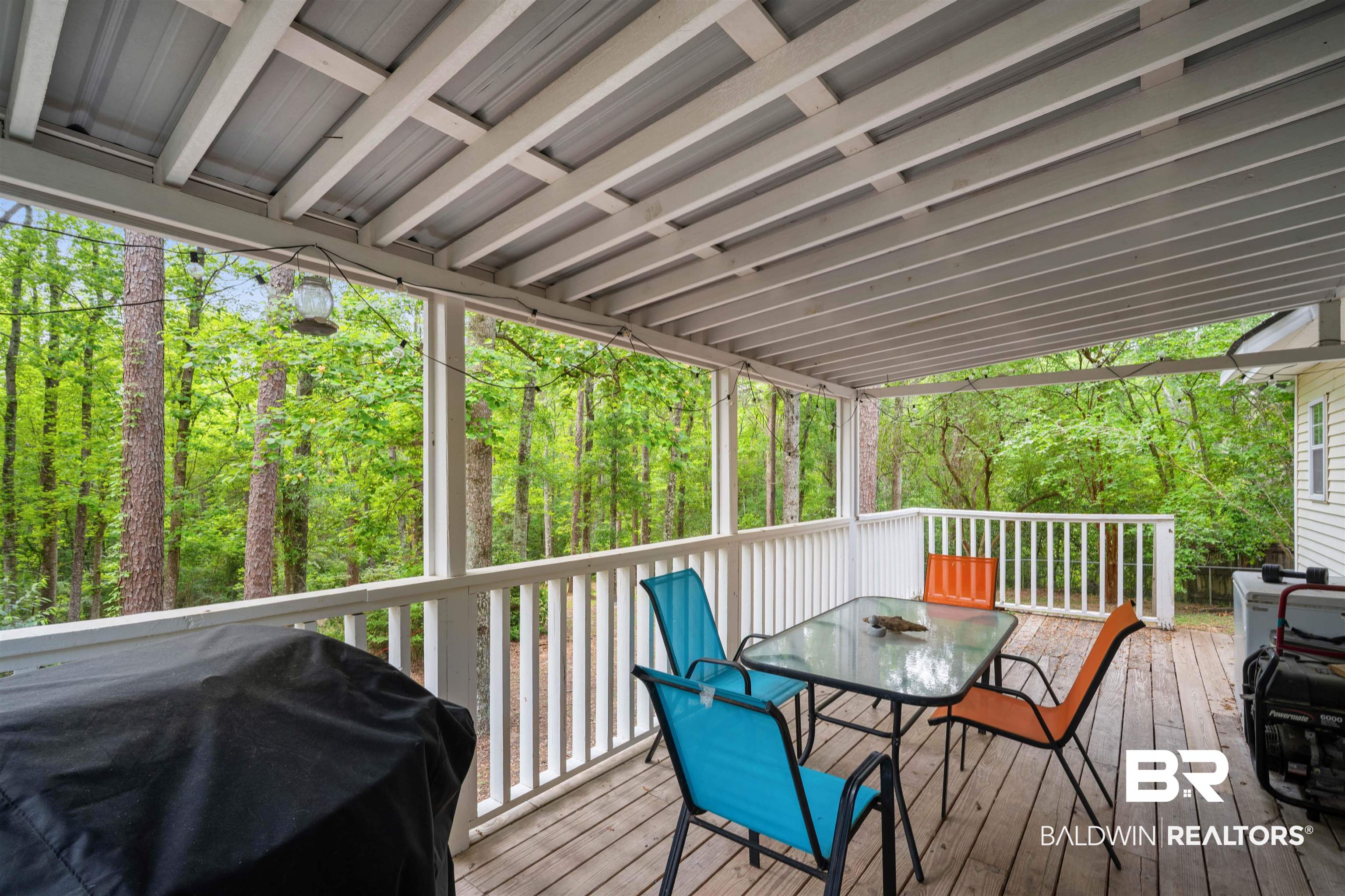 2823 Woodland Road Mobile, AL 36693 - Photo 23 of 29 Wooden deck featuring grilling area, outdoor dining space, and a forest view