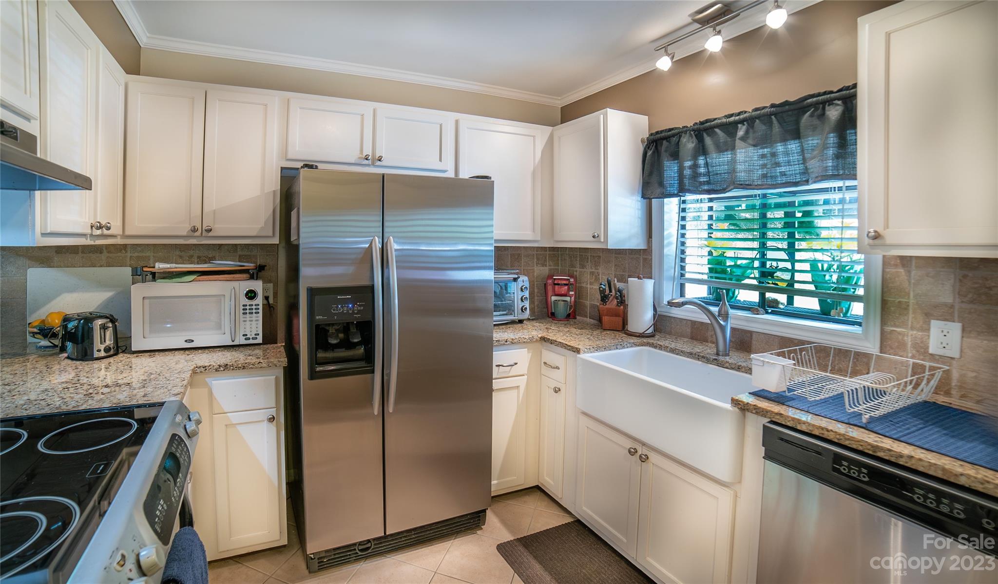 309 Victory Trail Morganton, NC 28655 - Photo 5 of 24 a kitchen with a refrigerator sink and cabinets