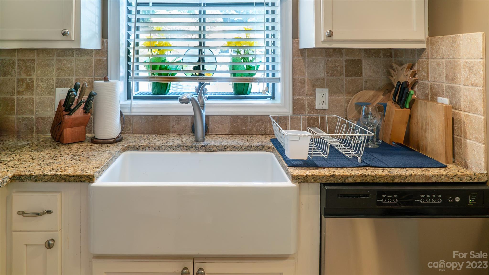 309 Victory Trail Morganton, NC 28655 - Photo 7 of 24 a kitchen with granite countertop a sink a counter top space and cabinets