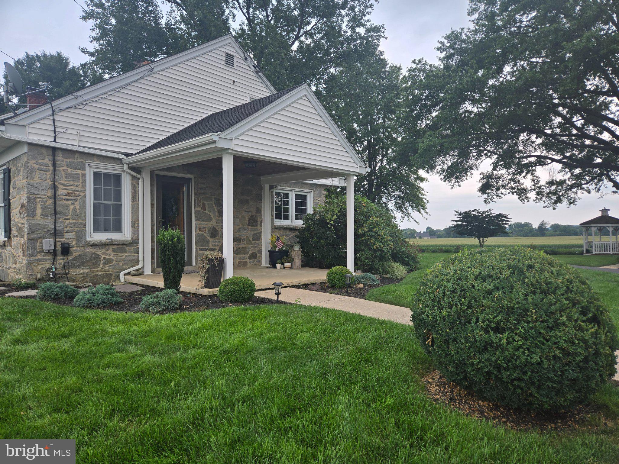 1262 Graystone Road, Unit 1262 Manheim, PA 17545 - Photo 3 of 9 Charming stone home with lush greenery.
