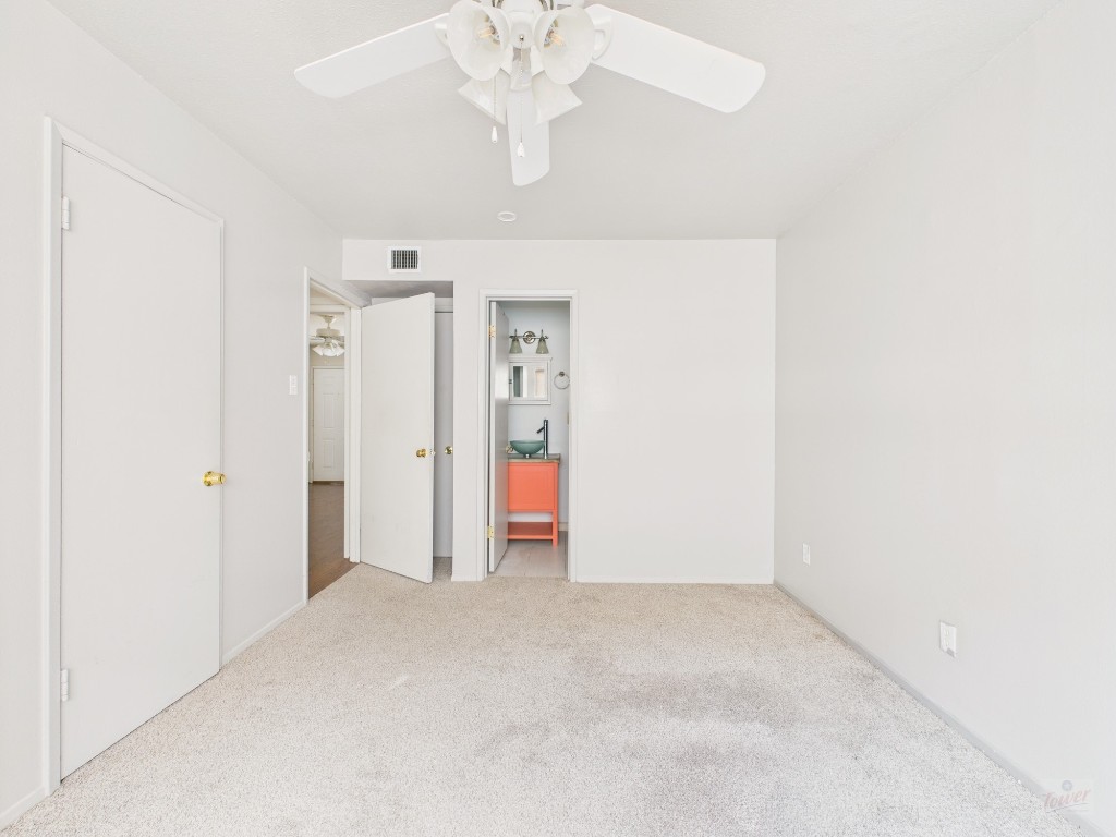 803 West 28th Street, Unit 202 Austin, TX 78705 - Photo 11 of 23 an empty room with a chandelier fan and closet