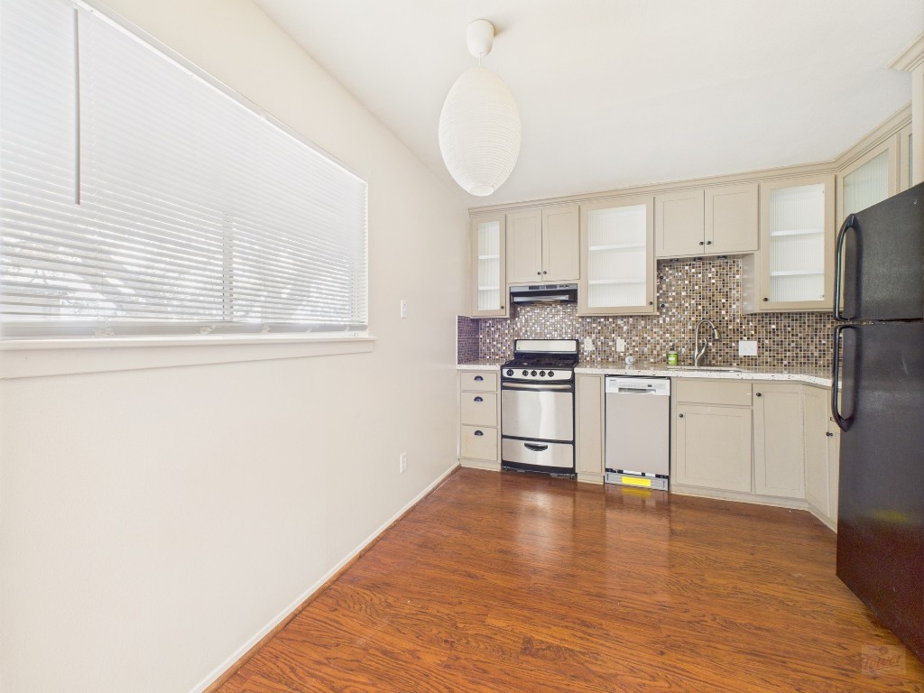 803 West 28th Street, Unit 202 Austin, TX 78705 - Photo 2 of 23 a kitchen with stainless steel appliances a refrigerator sink and cabinets
