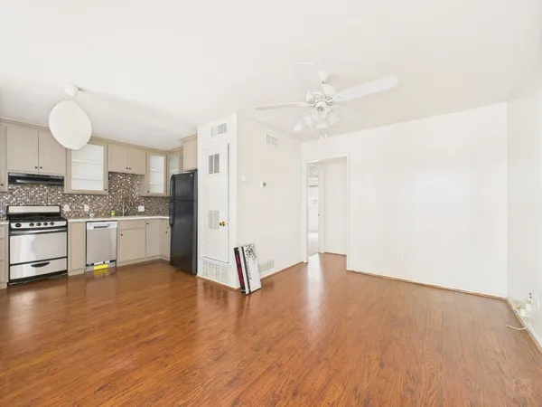 a view of a kitchen with wooden floor and a sink