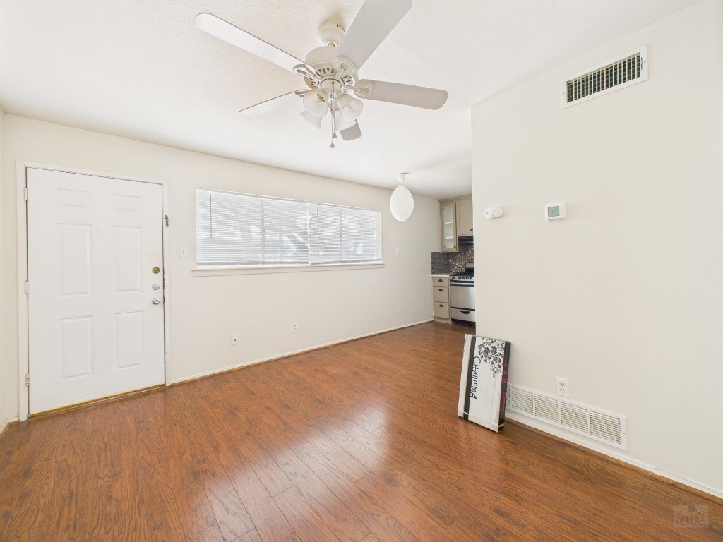 803 West 28th Street, Unit 202 Austin, TX 78705 - Photo 4 of 23 an empty room with wooden floor and windows