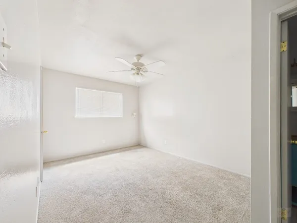 a view of an empty room with a fan