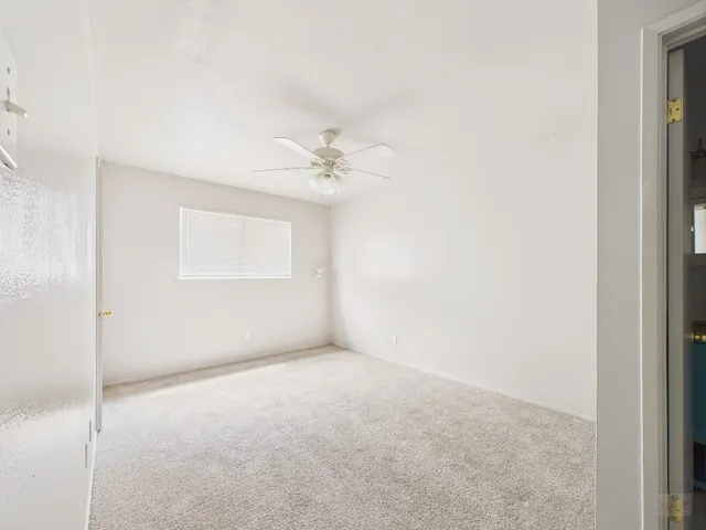 a view of an empty room with a fan
