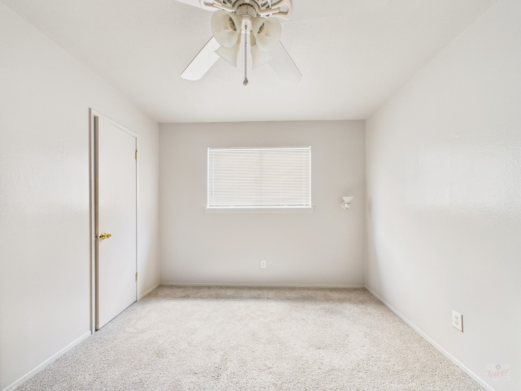 803 West 28th Street, Unit 202 Austin, TX 78705 - Photo 7 of 23 an empty room with a chandelier fan