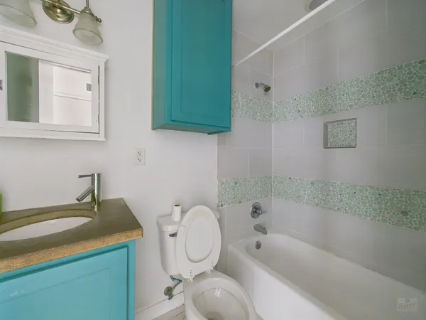 a bathroom with a sink a toilet and bathtub