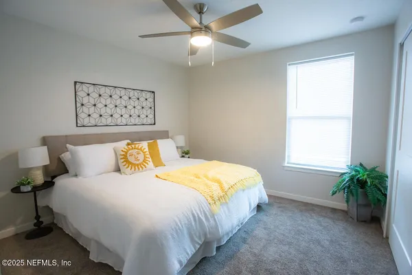 a bedroom with a bed and a window