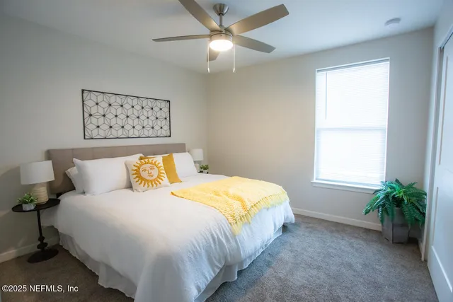 a bedroom with a bed and a window